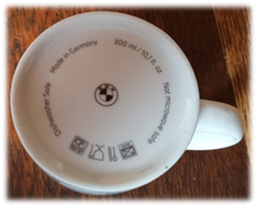 A white mug with black text on it

Description automatically generated