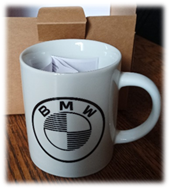 A white mug with a logo on it

Description automatically generated