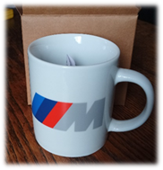 A white mug with a logo on it

Description automatically generated